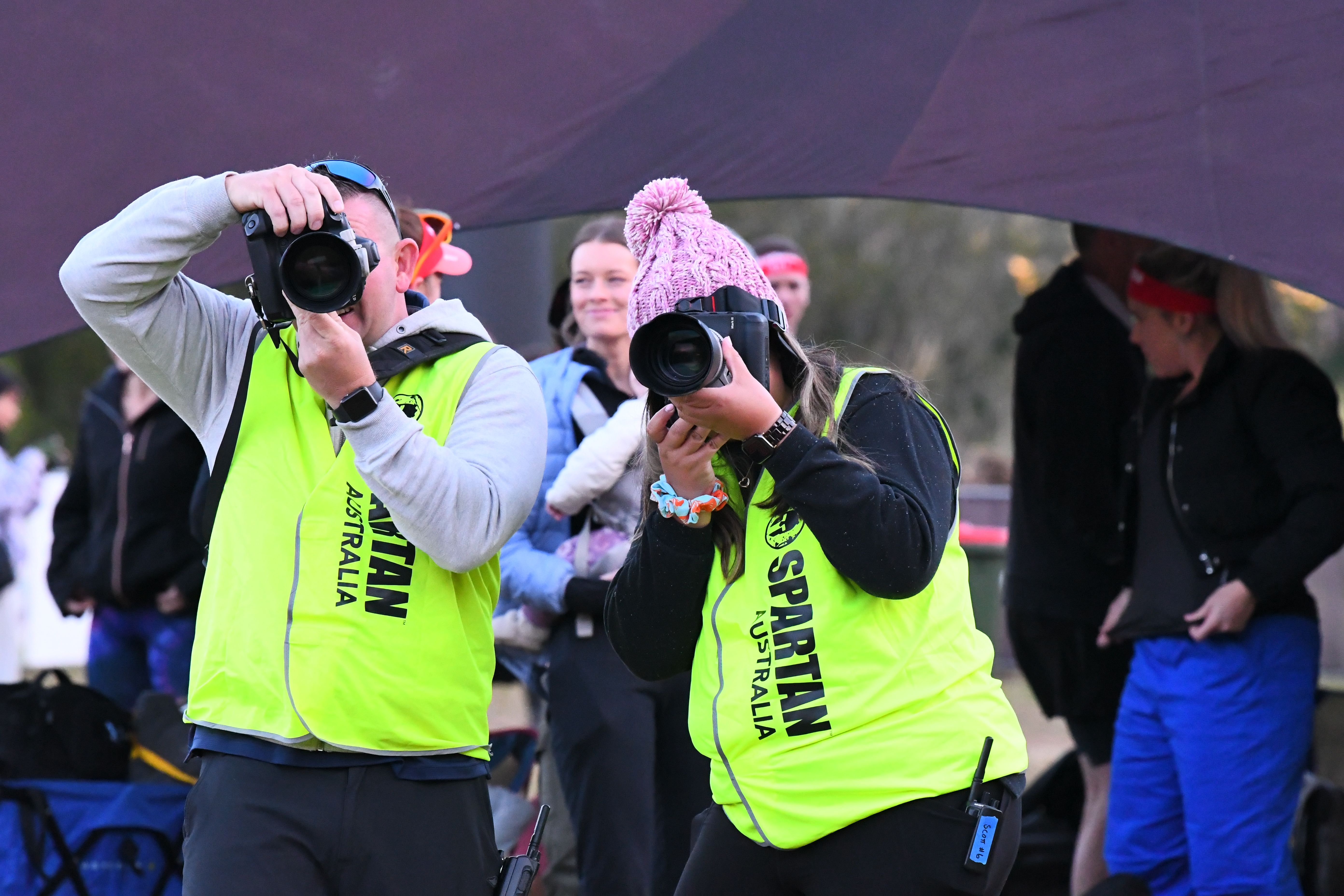 Two event photographers working trackside at a Spartan event