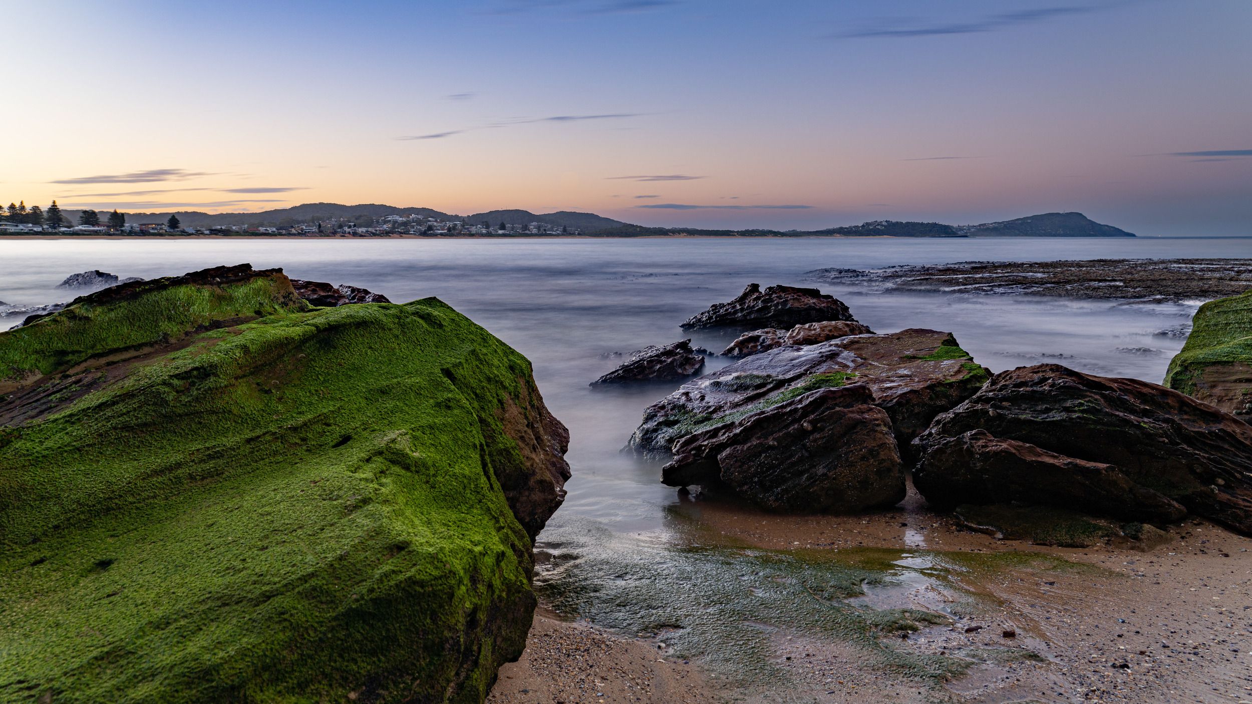 Ocean pools and rock shelves on the coast at Terrigal in soft evening light